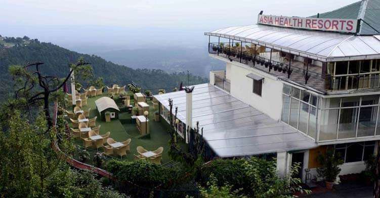 a resort with a huge lawn in mountains