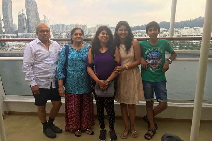 saurabhi singapore family trip: family posing before views from cruise