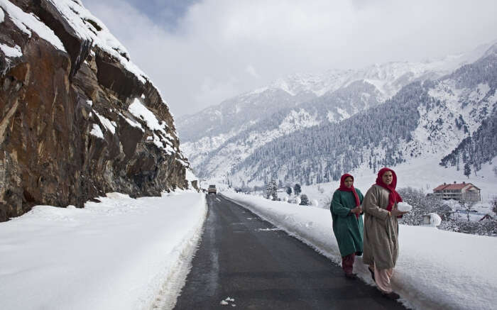 Locals during snow in Kashmir