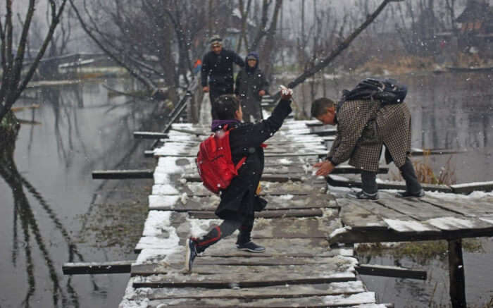 School girl enjoying fresh snowfall in Kashmir 2017