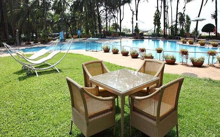 Table laid out by the swimming pool in The Resort Mumbai