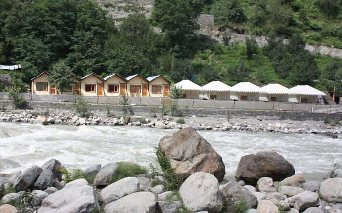 Tents of Kia Camps by the river in Manali 