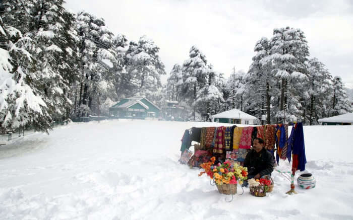 shopkeeper during snowfall in Kashmir