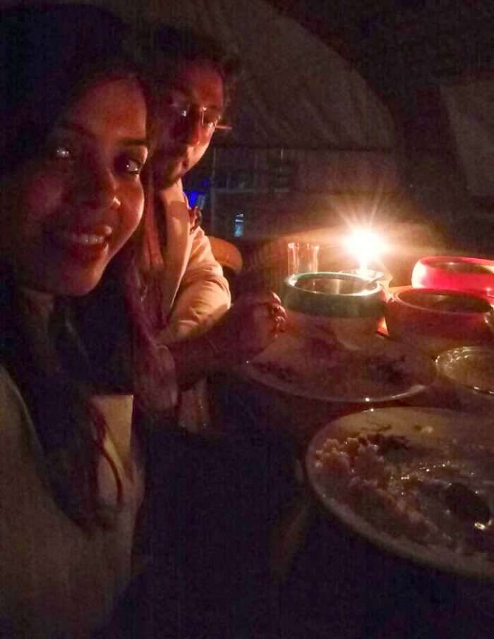 Couple enjoying a candlelight dinner on a houseboat