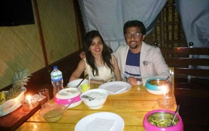 Couple enjoying a candlelight dinner on a houseboat