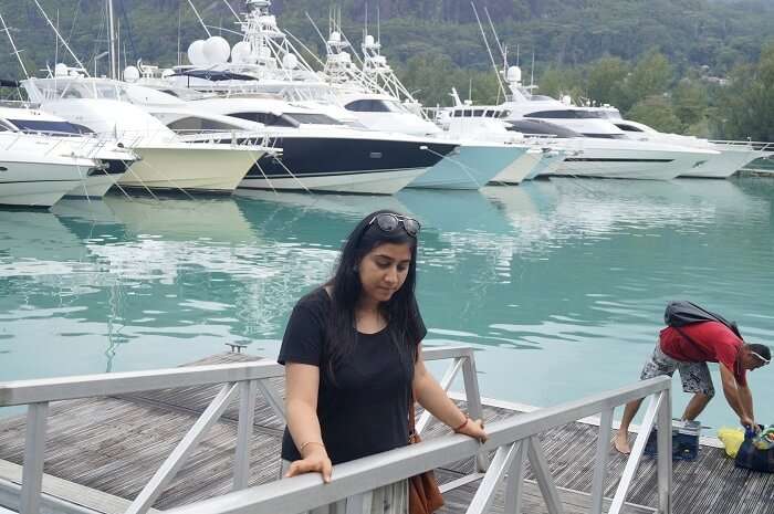 Keshavs wife at a dock in Seychelles