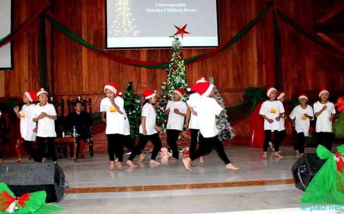 Kids wearing santa caps on stage 