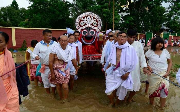 Manipuri people carrying idol of god during festival 