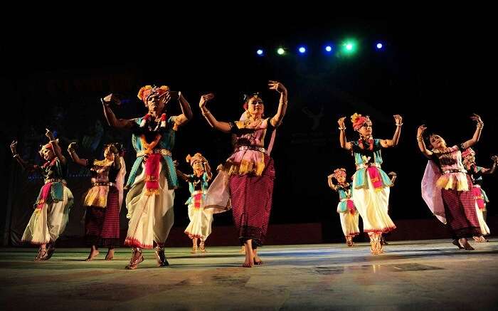 Manipuri people dancing on stage during a festival 
