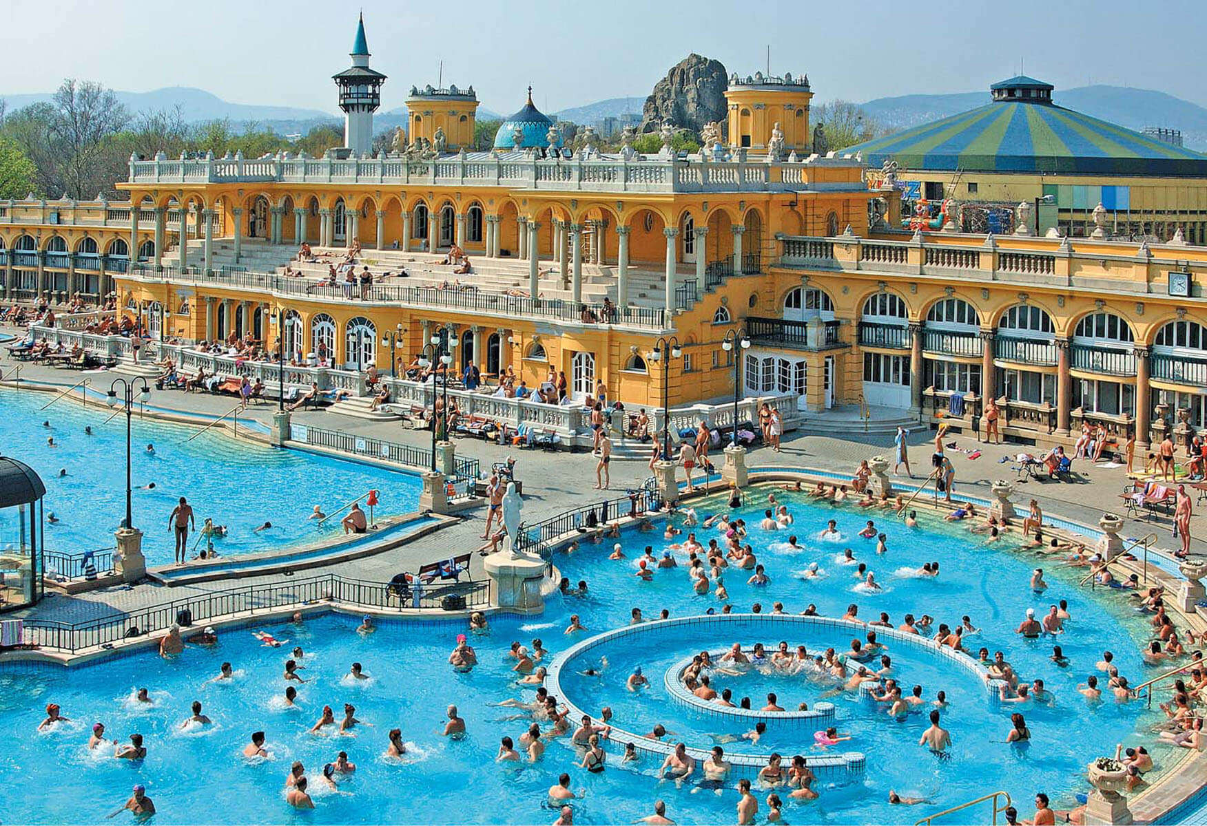 hundreds of people enjoying in an open pool