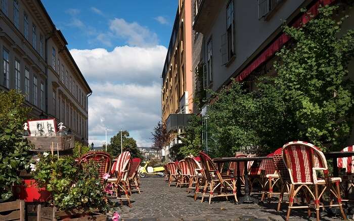 A café with red and white chairs on the street 