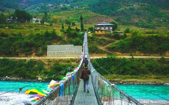 A traveler crossing the bridge leading to Haa Valley