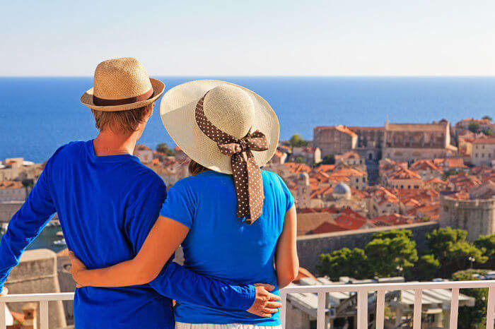 a couple wearing blue clothes enjoying views in a European city