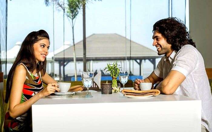 Couple having lunch at Golden Beach resort Daman