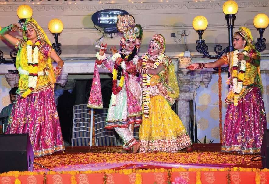 girl and boy dressed in Radha Krishna attire for holi