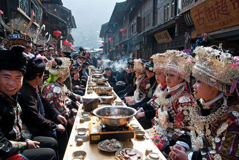 a bunch of people eating on a long table on valentines day