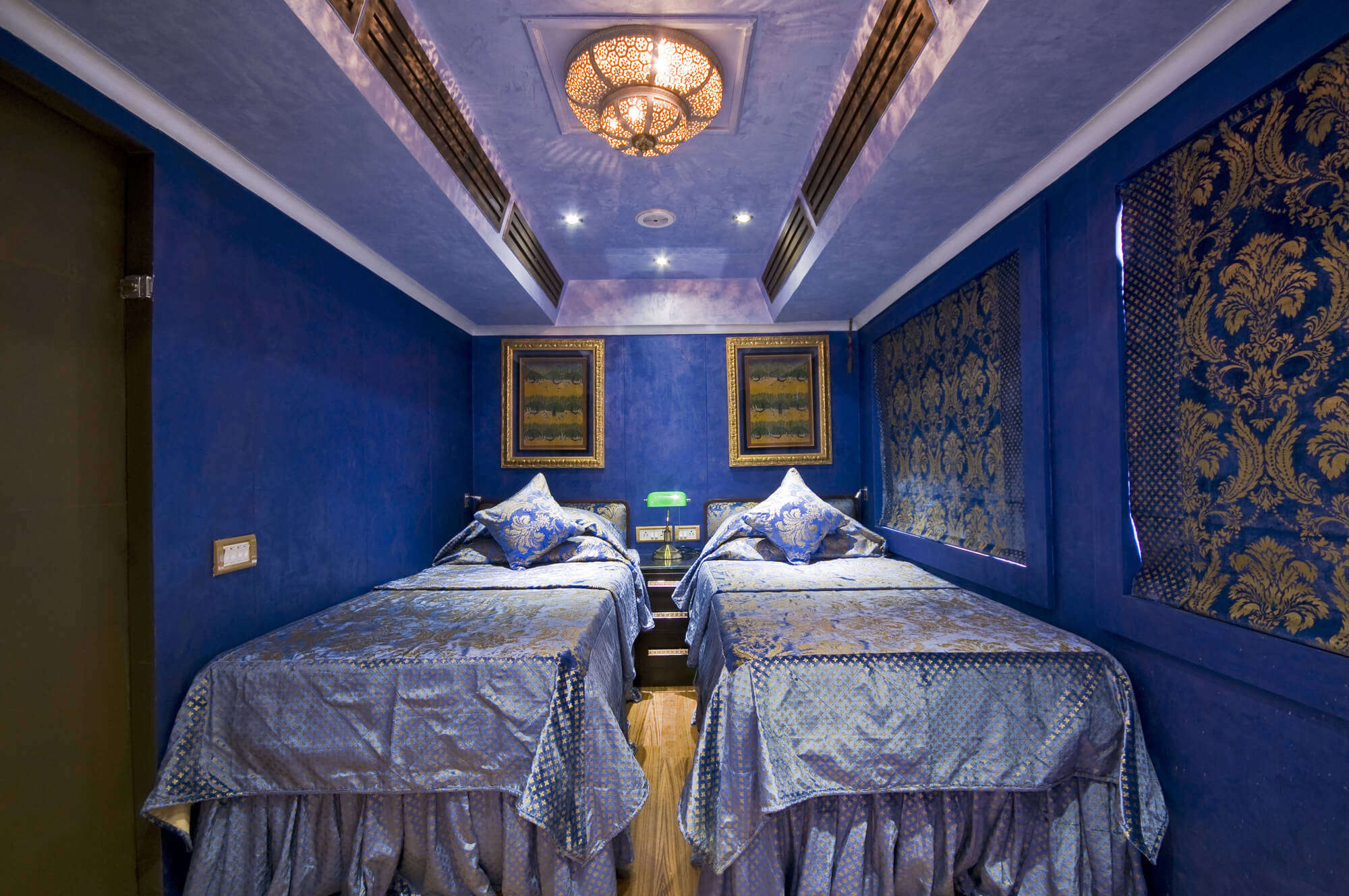 a blue coach with luxurious bed in a luxurious train