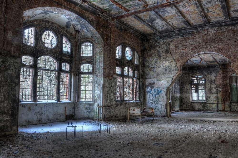 old chairs and a bed in an abandoned hospital