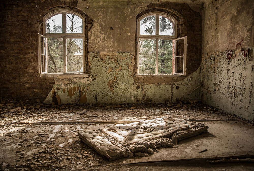 a mattress in an abandoned hospital