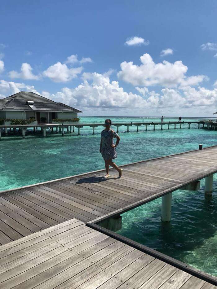 nihals wife in front of the water villa