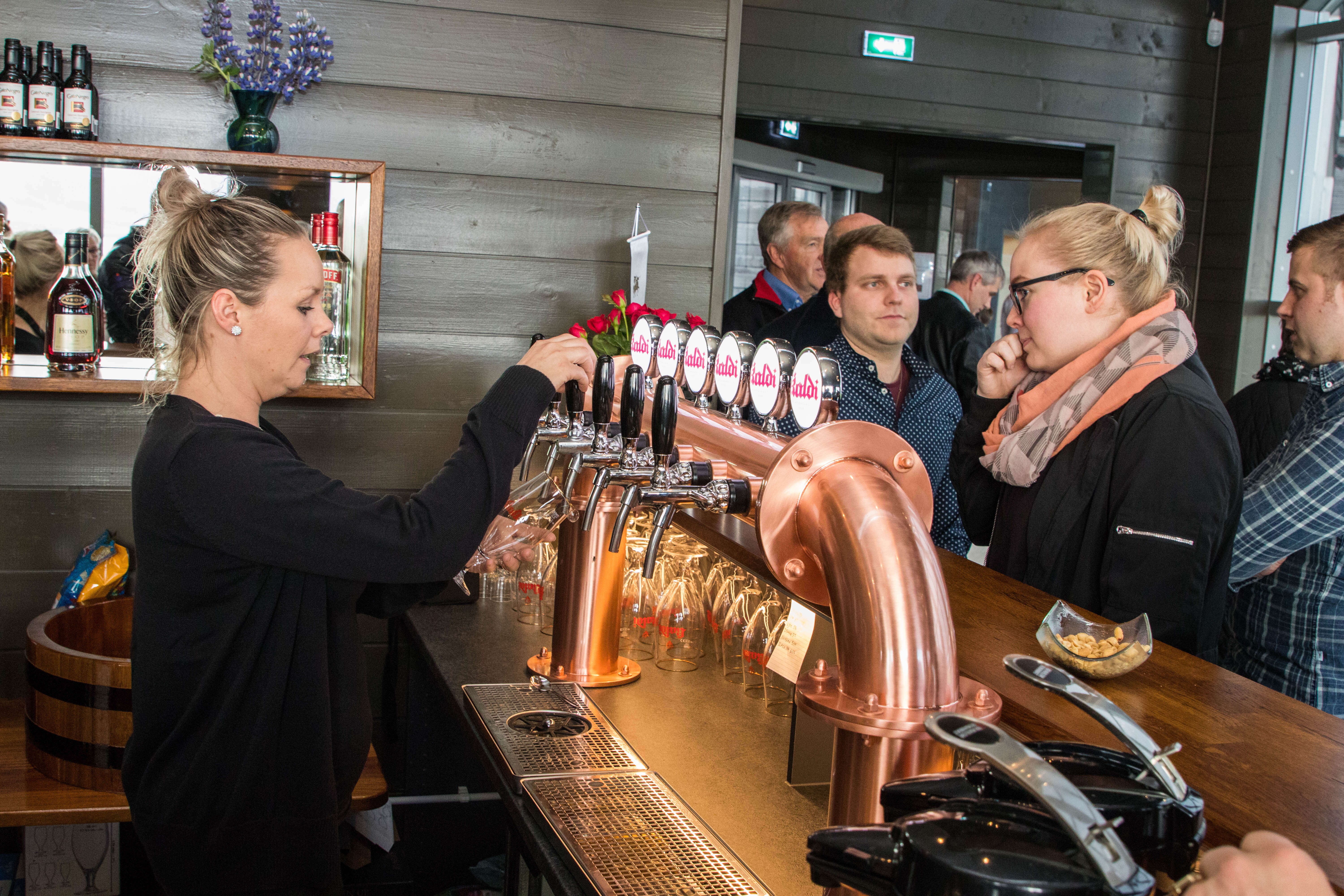 people buying beer at beer spa counter