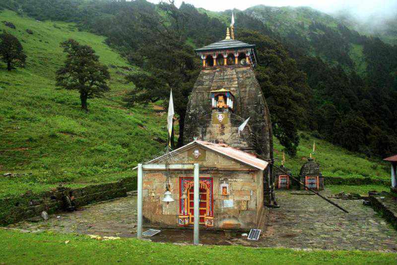 an ancient temple amid lush green mountains