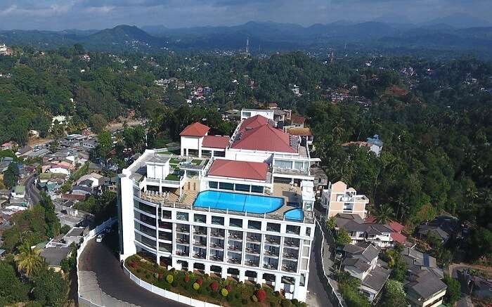 a grand hotel with a terrace pool 