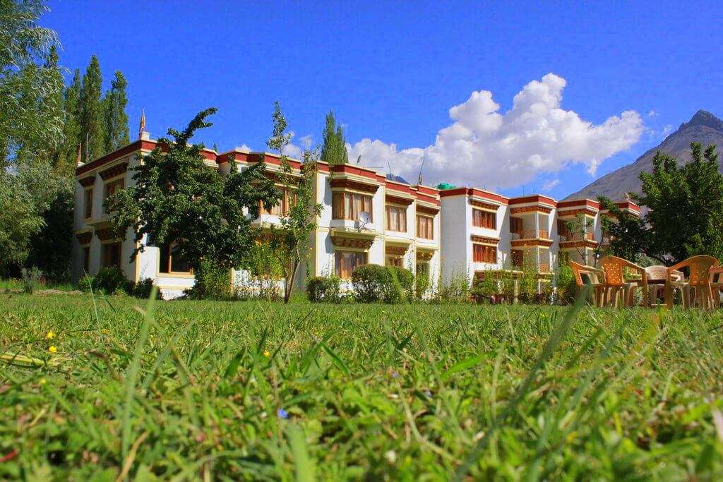 a hotel with mountains in background 