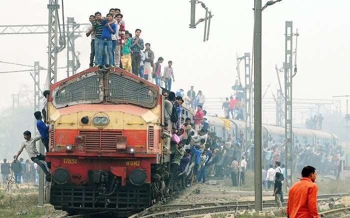 People standing on top of a train in India