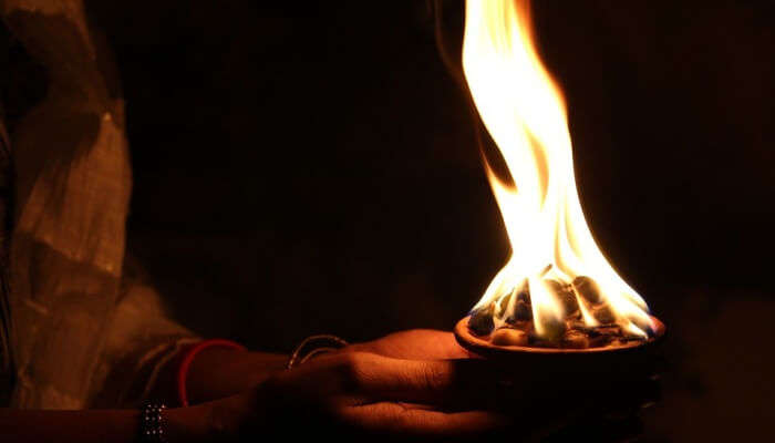 woman's hands holding a diya at Daat Kali Temple, one of the top places to visit in Dehradun