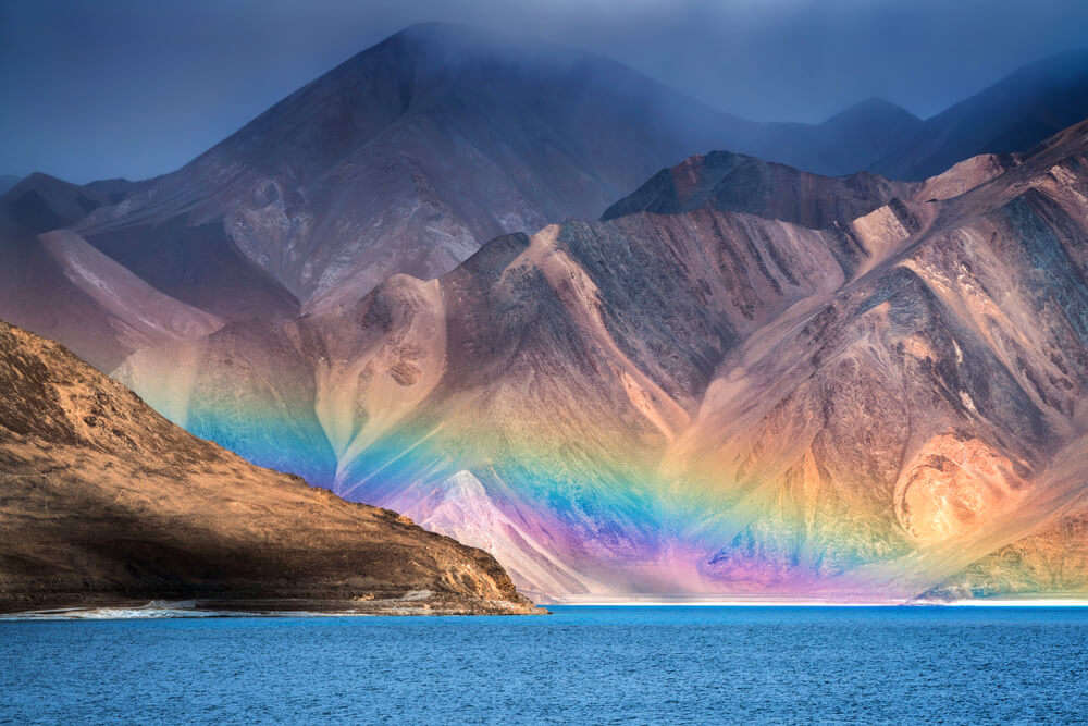 rainbow in mountains over a lake