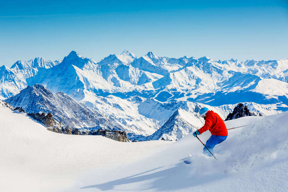 A man skiing in Dent Blanche slopes wearing red jacket
