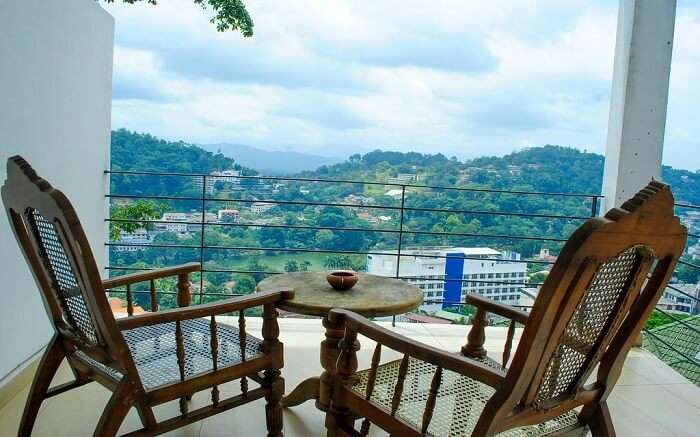 two wooden chairs in balcony with mountain views 