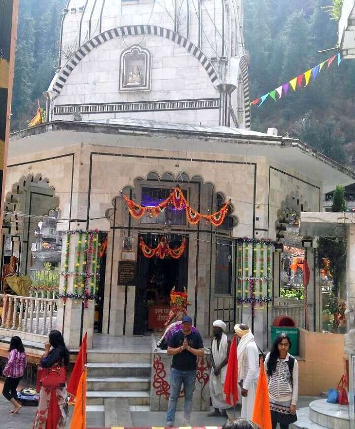 kuldeep manali honeymoon trip: posing outside manikaran temple