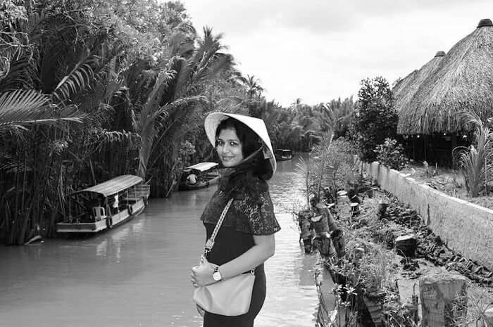 pallavi vietnam family trip: posing near mekong river