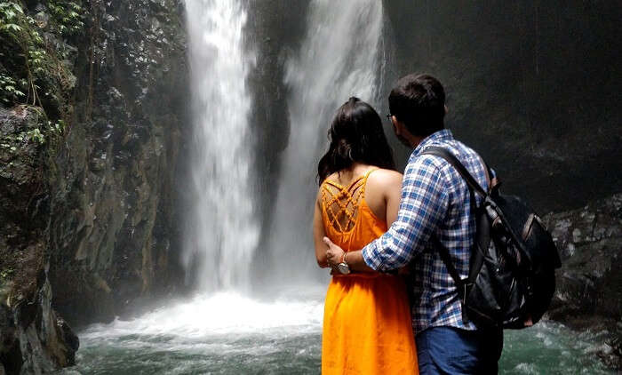 couple witnessing the gitgit waterfall