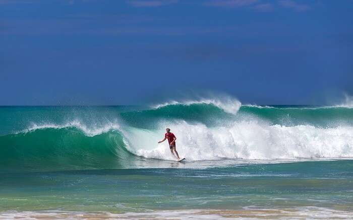a man surfing on high tides