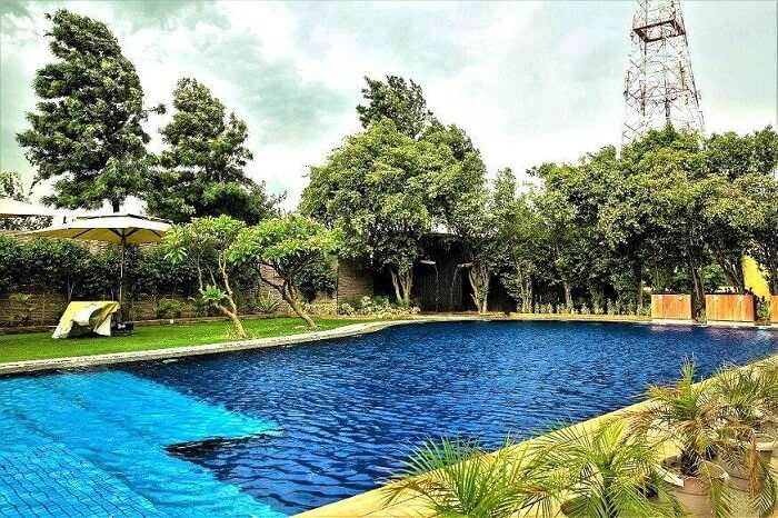 Chill and relax in the pool of aravali resort and expeirence one of the best resorts near Delhi