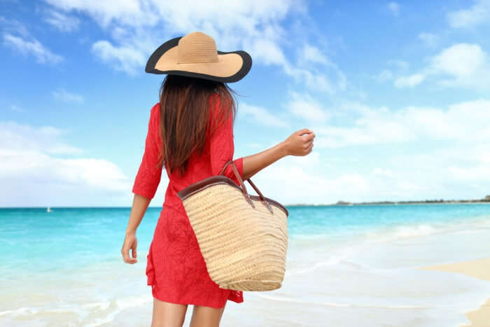 girl carrying bag to the beach