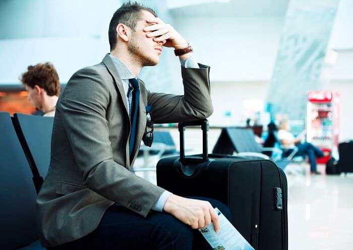 flight delayed stressed man