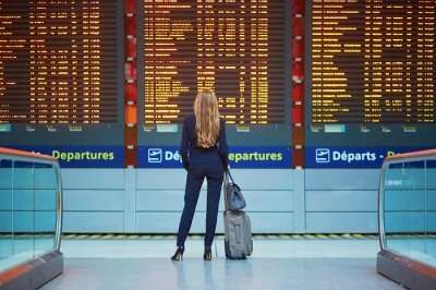 a woman checking flight status at airport
