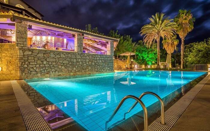 a beautifully lit outdoor pool in a resort 