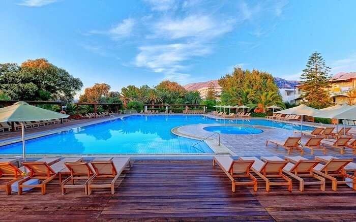 an outdoor pool with wooden sundecks around it 