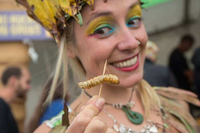 A woman about to eat a worm at the Hokitika Wildfood Festival, NZ