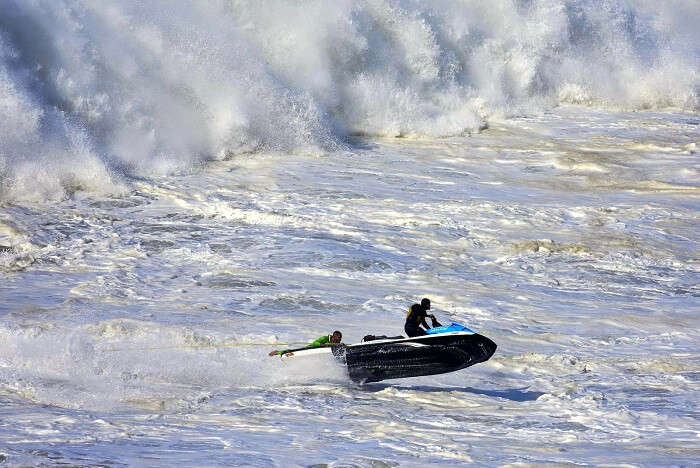 Surf 100 feet high waves in Nazare portugal