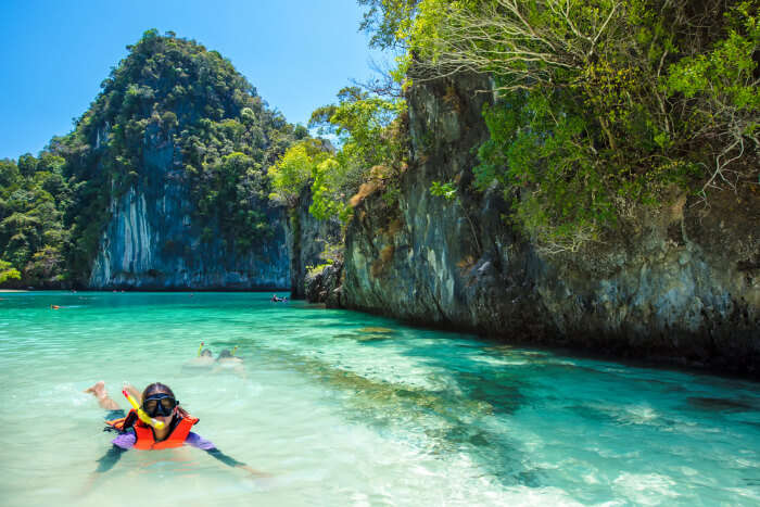 A kid snorkeling in Hong Island in Thailand