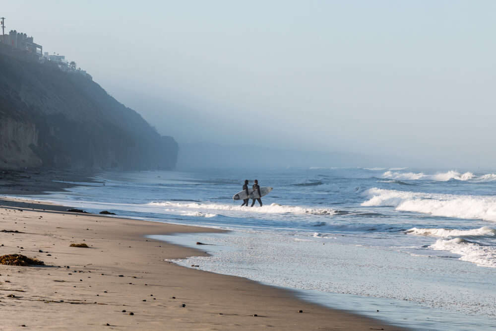 Amateur beach nudists stretching on the golden sand