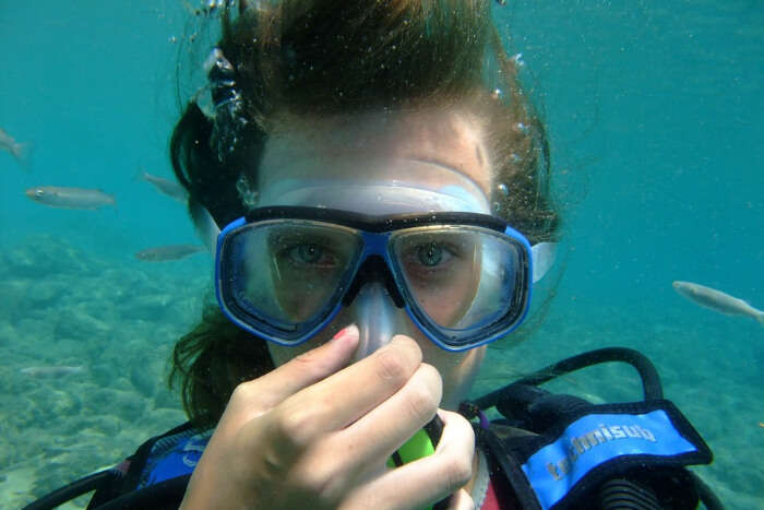 A diver holding her breathe under water