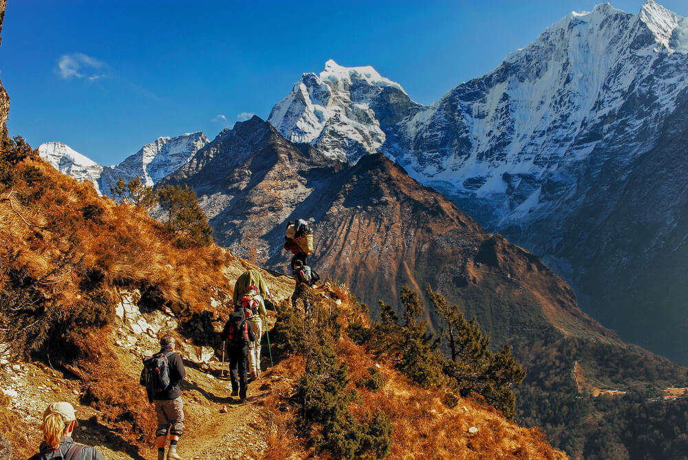 people trekking through mountains