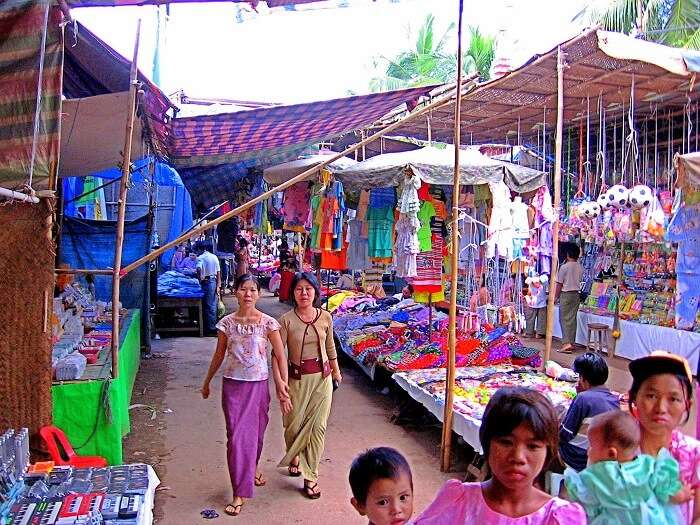 Women buying things from the street market in Myanmar